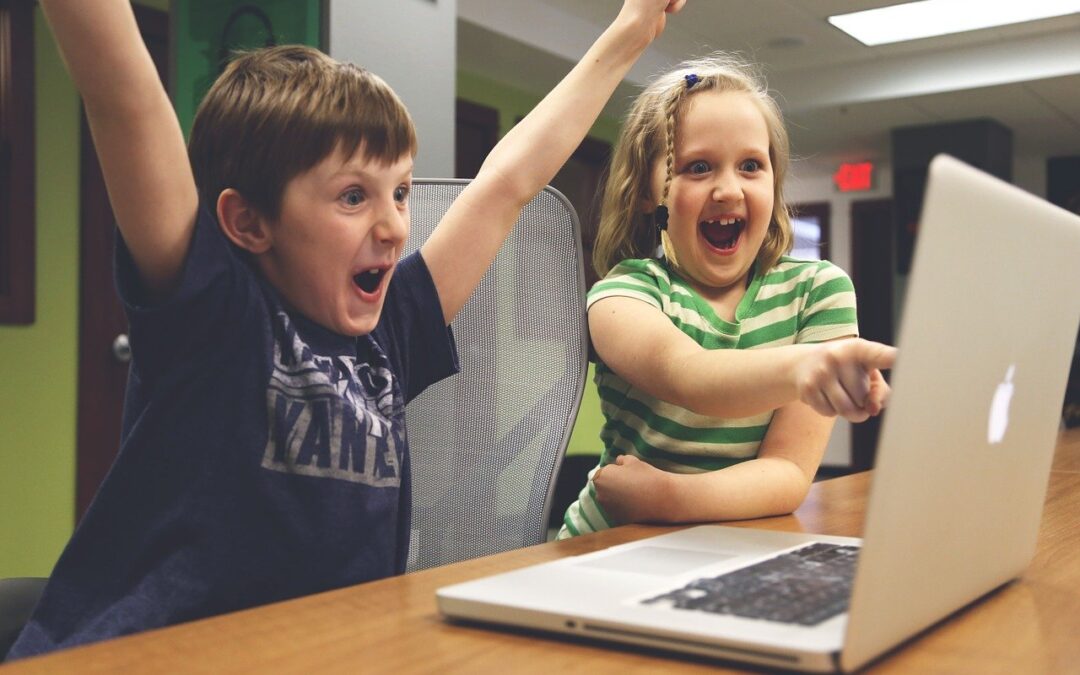 children looking at something on a laptop