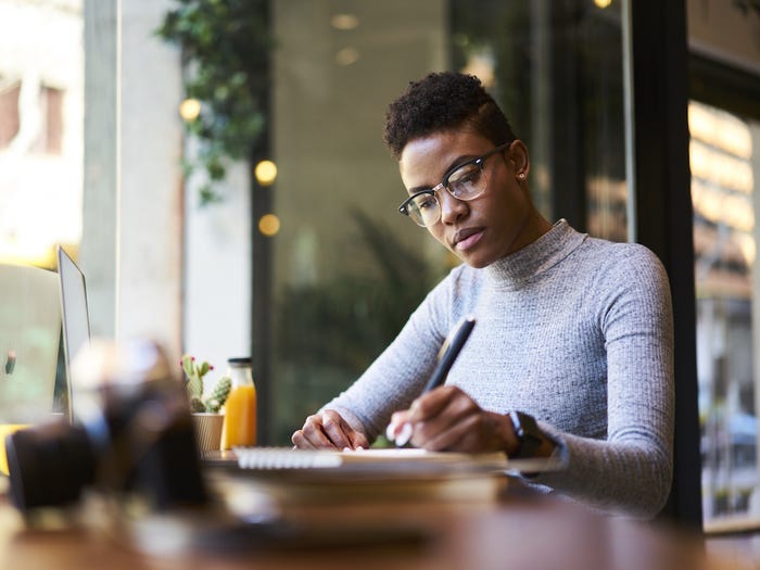 woman writing in a notebook