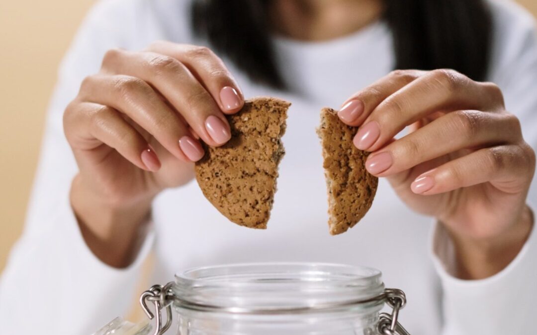 woman breaking a cookie