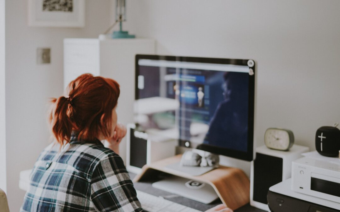 a person sitting in front of the computer screen