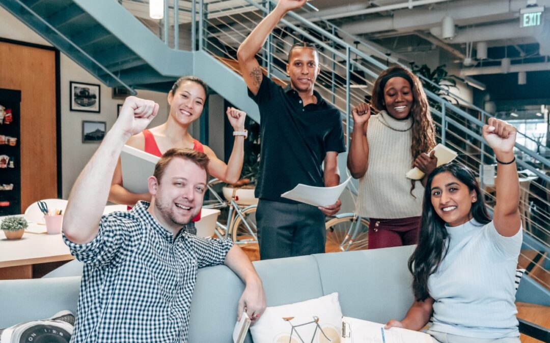 people cheering and raising a fist