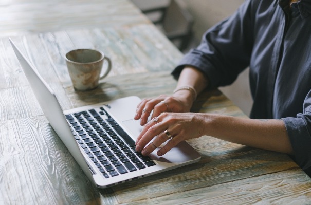a person typing on a laptop